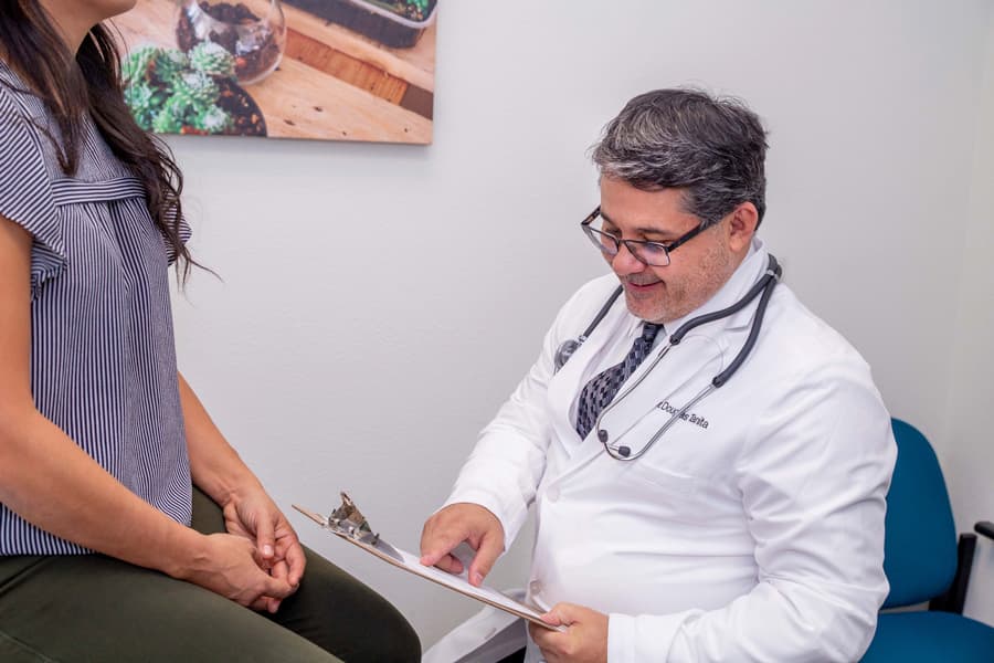 Dr. Tanita of Henderson Women's Care working with a patient